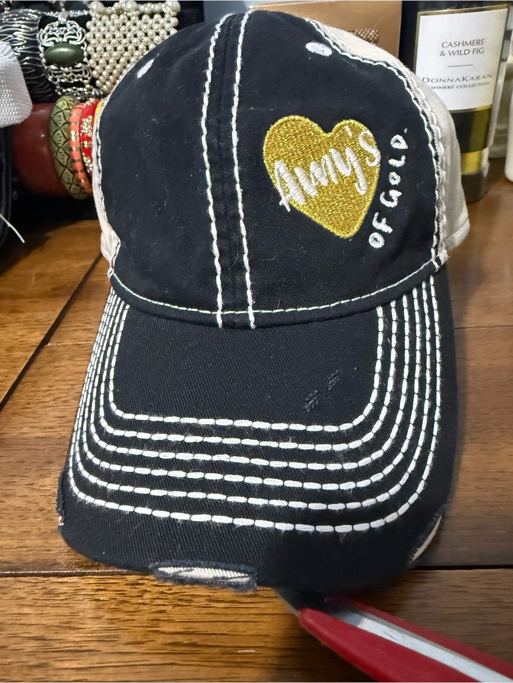 Distressed Adams women Black and Tan Cap with white logo and gold heart.